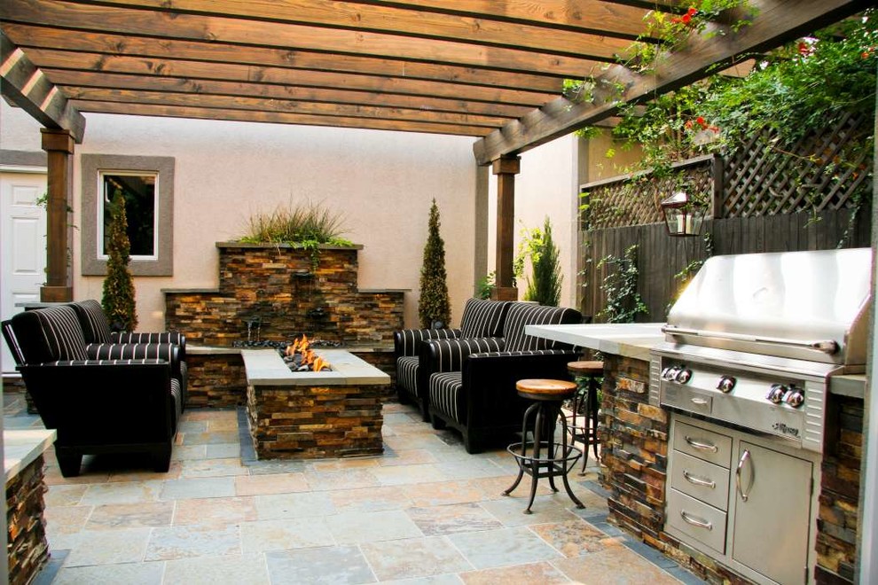 Inspiration for a small rustic back patio in Denver with an outdoor kitchen, tiled flooring and a pergola.