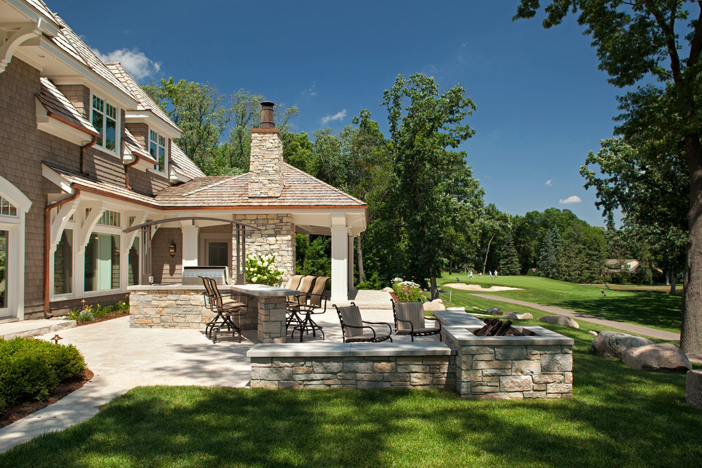 Example of a classic patio design in Minneapolis with a fire pit