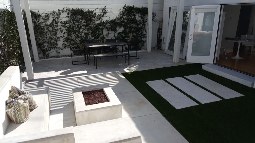 Design ideas for a small modern back patio in Los Angeles with a fire feature, concrete slabs and a gazebo.