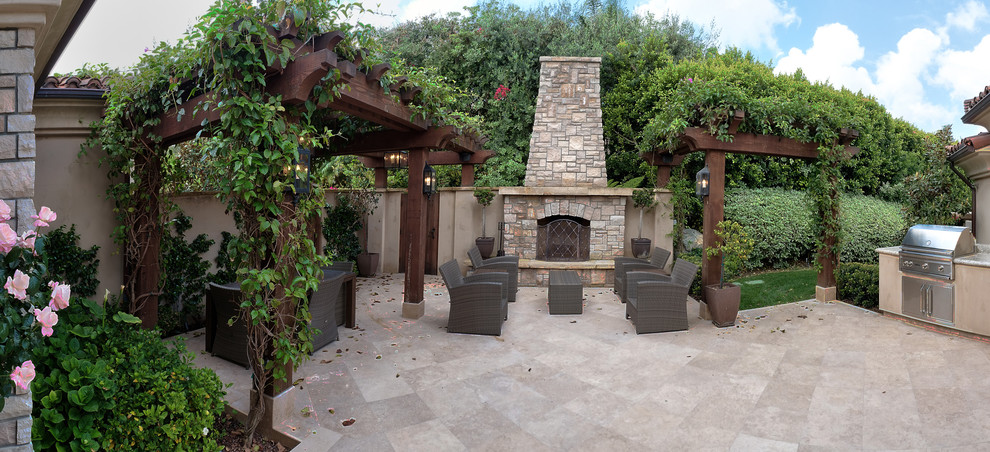 Example of a mid-sized tuscan courtyard concrete patio design in San Diego with a fire pit and a pergola