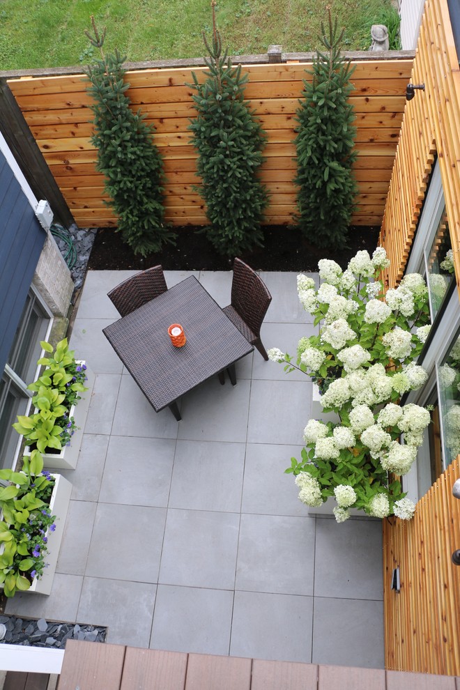 Свежая идея для дизайна: маленький двор на заднем дворе в современном стиле с покрытием из плитки без защиты от солнца для на участке и в саду - отличное фото интерьера
