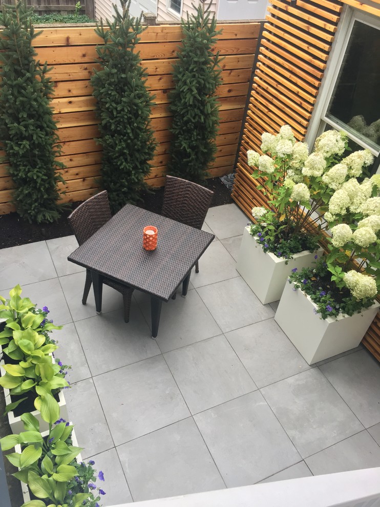Foto de patio actual pequeño sin cubierta en patio trasero con suelo de baldosas