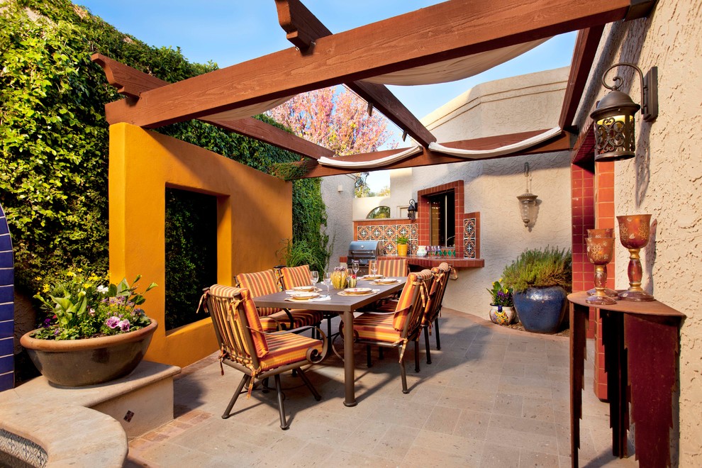 Inspiration for a mediterranean patio in Phoenix with a pergola.