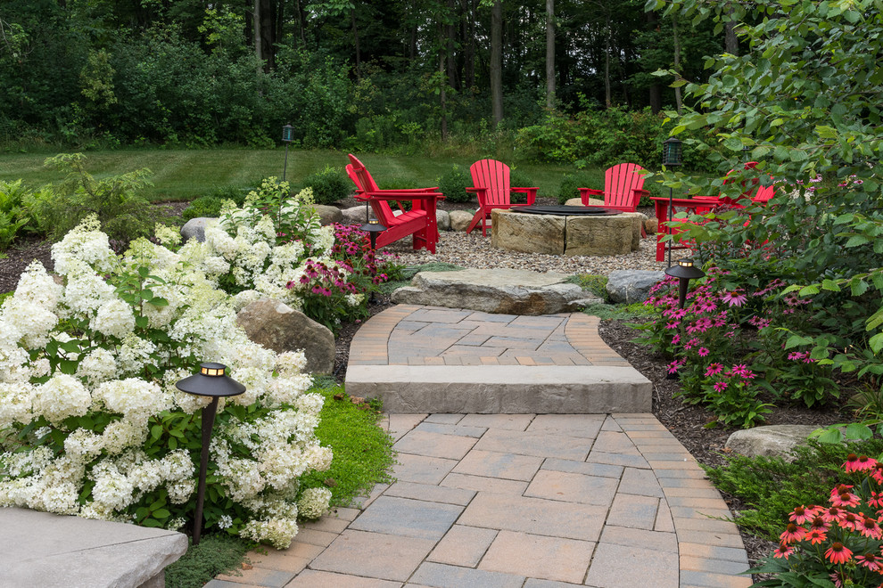 Patio - large contemporary backyard gravel patio idea in Cleveland with a fire pit and no cover