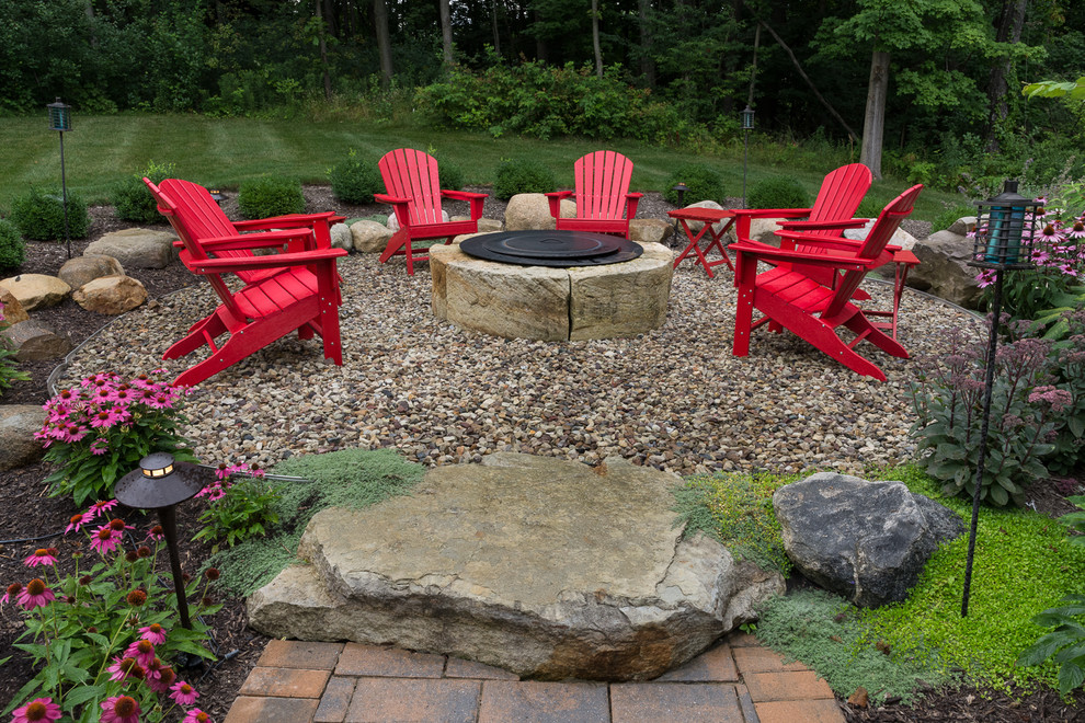Design ideas for a large contemporary back patio in Cleveland with a fire feature, gravel and no cover.