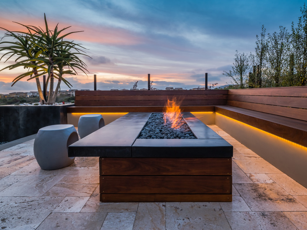 This is an example of a contemporary patio in San Diego with a fire feature, tiled flooring and no cover.