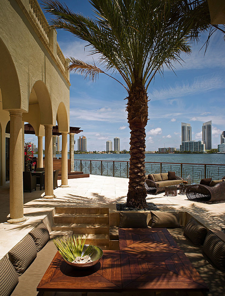 Photo of a large nautical back patio in Miami with no cover.