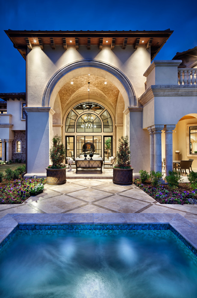 Huge tuscan backyard patio fountain photo in Houston with a roof extension