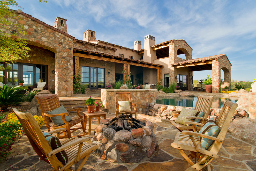 Inspiration for a mediterranean patio in Phoenix with a fire feature.