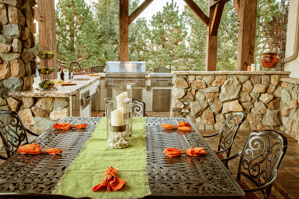 Design ideas for a large rustic back patio in Denver with an outdoor kitchen, concrete paving and a pergola.