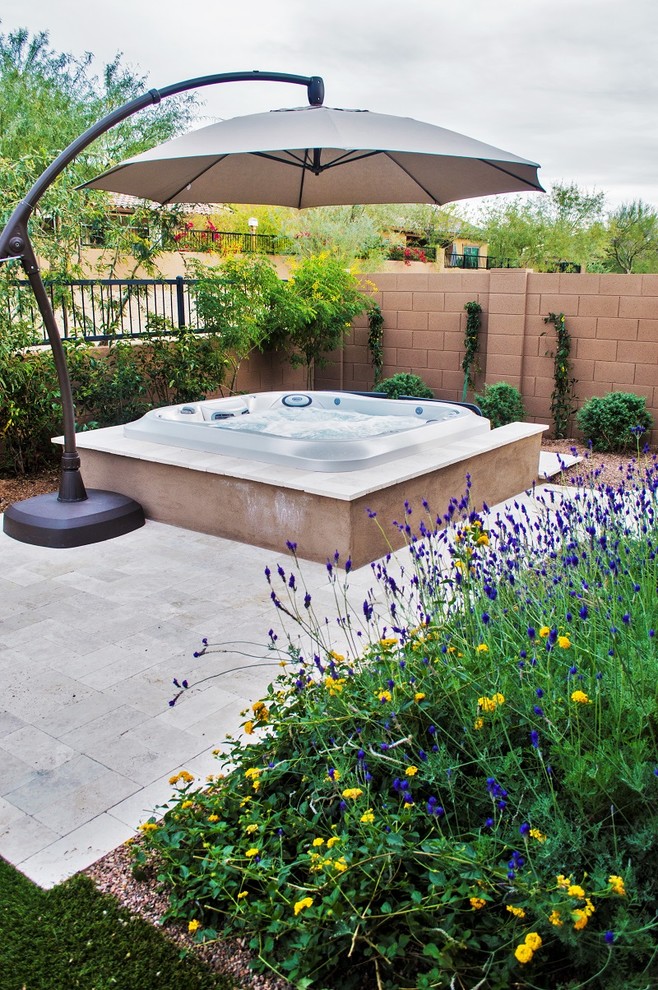 Example of a large classic backyard stamped concrete patio fountain design in Phoenix with a pergola