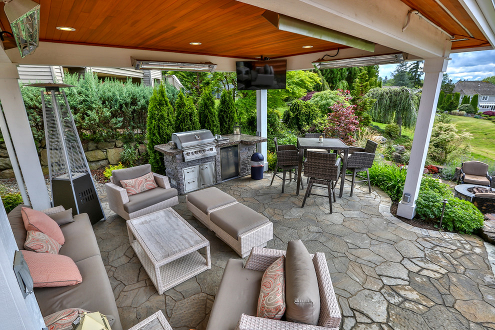 Imagen de patio tradicional renovado grande en patio trasero con cocina exterior, adoquines de piedra natural y cenador