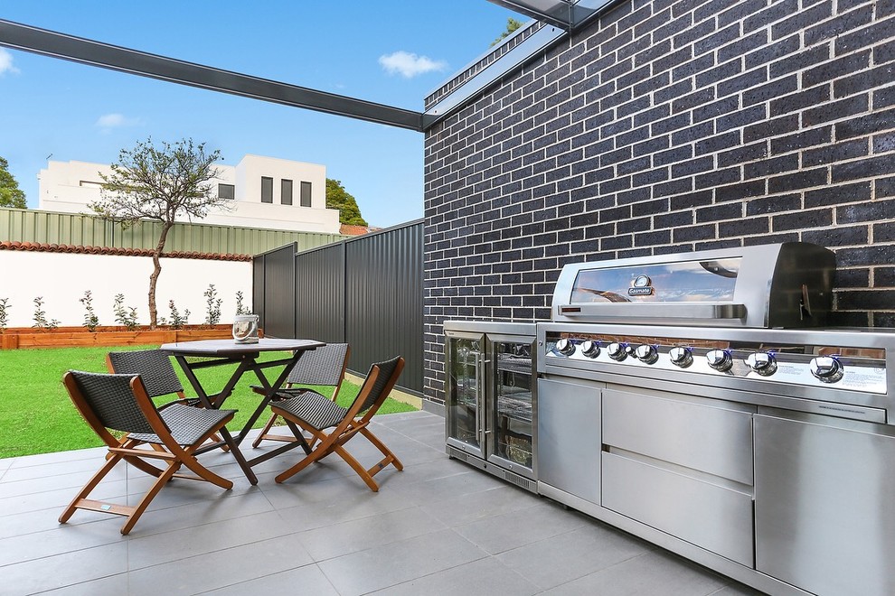 Photo of a contemporary back patio in Sydney with tiled flooring and a pergola.