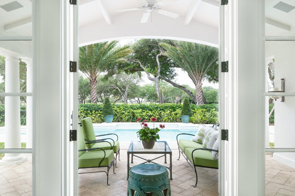 Design ideas for a world-inspired patio in Miami with a roof extension.