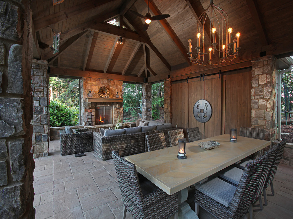 Design ideas for a large rustic back patio in Atlanta with natural stone paving, a pergola and a fireplace.