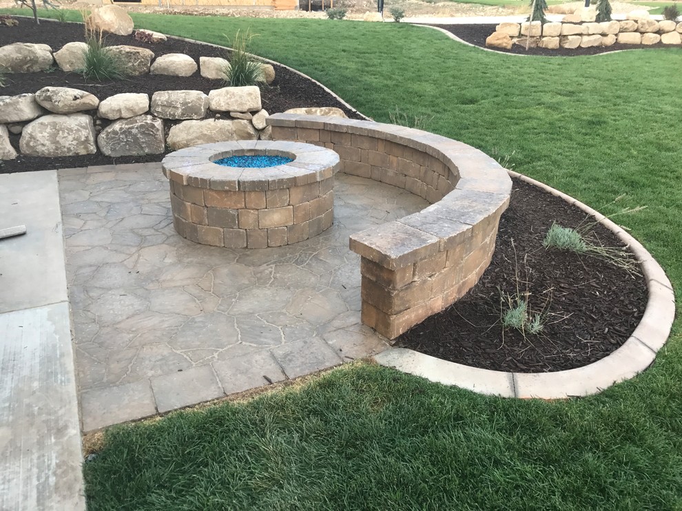Patio - mid-sized traditional backyard brick patio idea in Salt Lake City with a fire pit and no cover