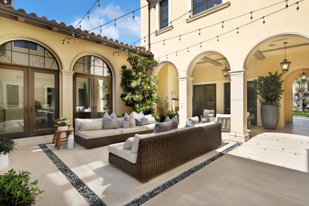 Tuscan courtyard patio photo in Orange County with no cover
