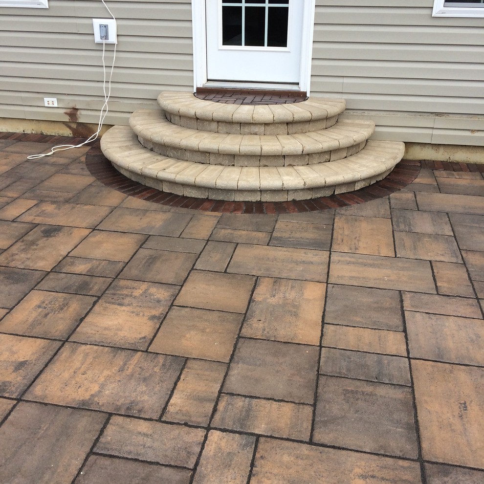 Inspiration for a mid-sized modern backyard brick patio remodel in Indianapolis with no cover