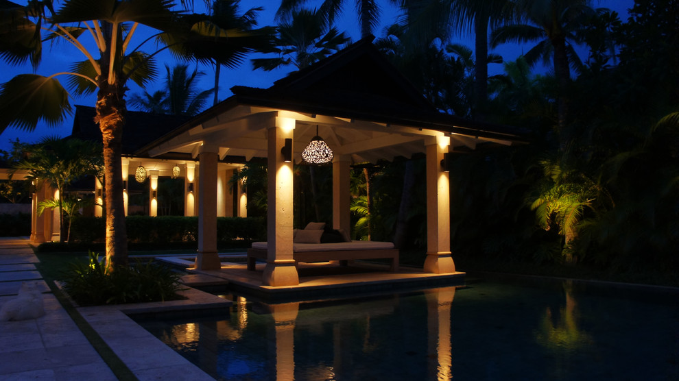 Expansive world-inspired back patio in Hawaii with an outdoor kitchen, tiled flooring and a gazebo.