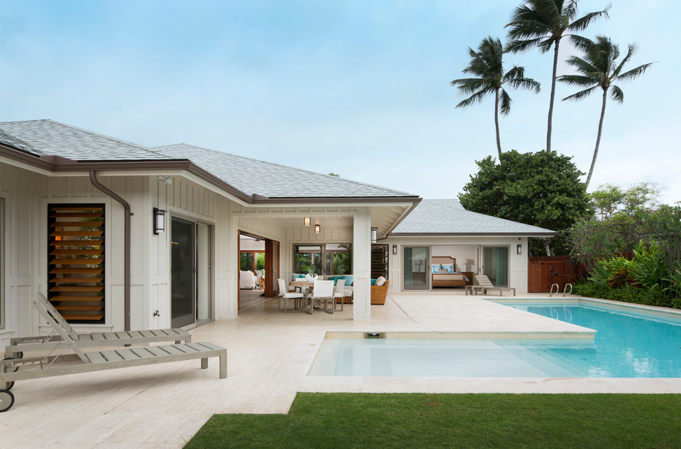 Patio - large coastal side yard tile patio idea in Hawaii with a roof extension