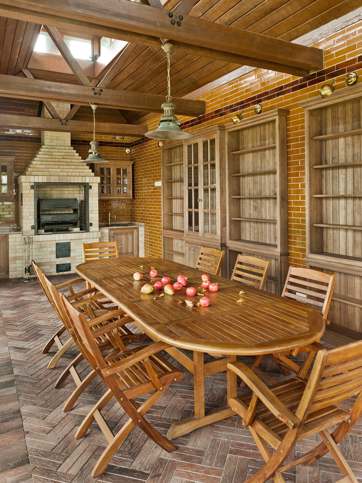 Exemple d'une terrasse nature avec une cuisine d'été et une extension de toiture.