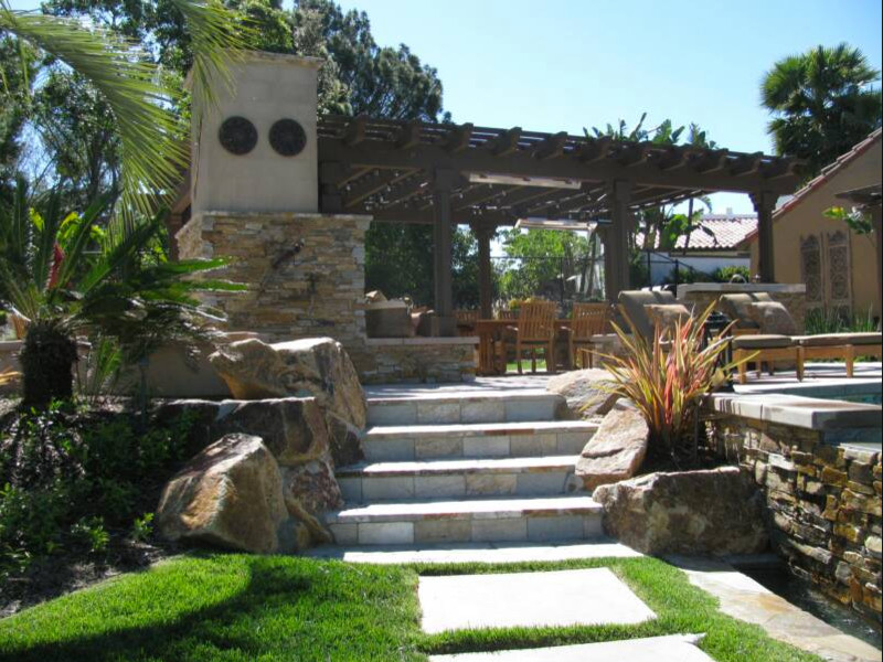 Photo of a large traditional back patio in San Diego with a fire feature and a pergola.