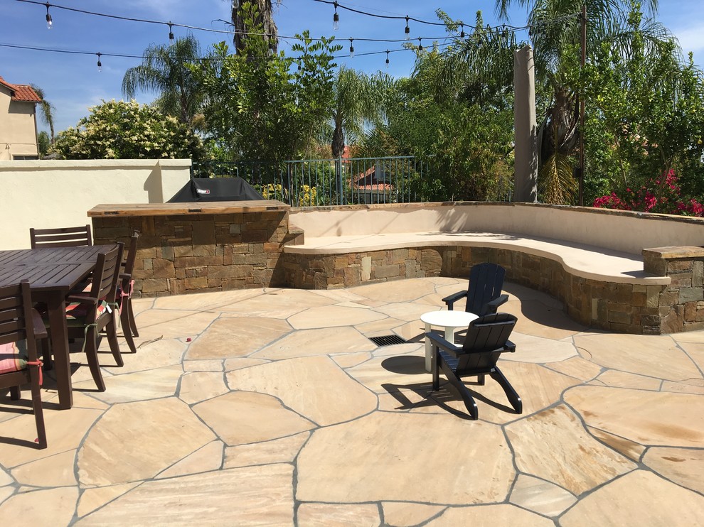 Mid-sized tuscan backyard stone patio kitchen photo in Los Angeles with no cover