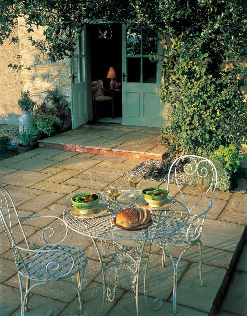 Traditional back patio in Hampshire with natural stone paving.
