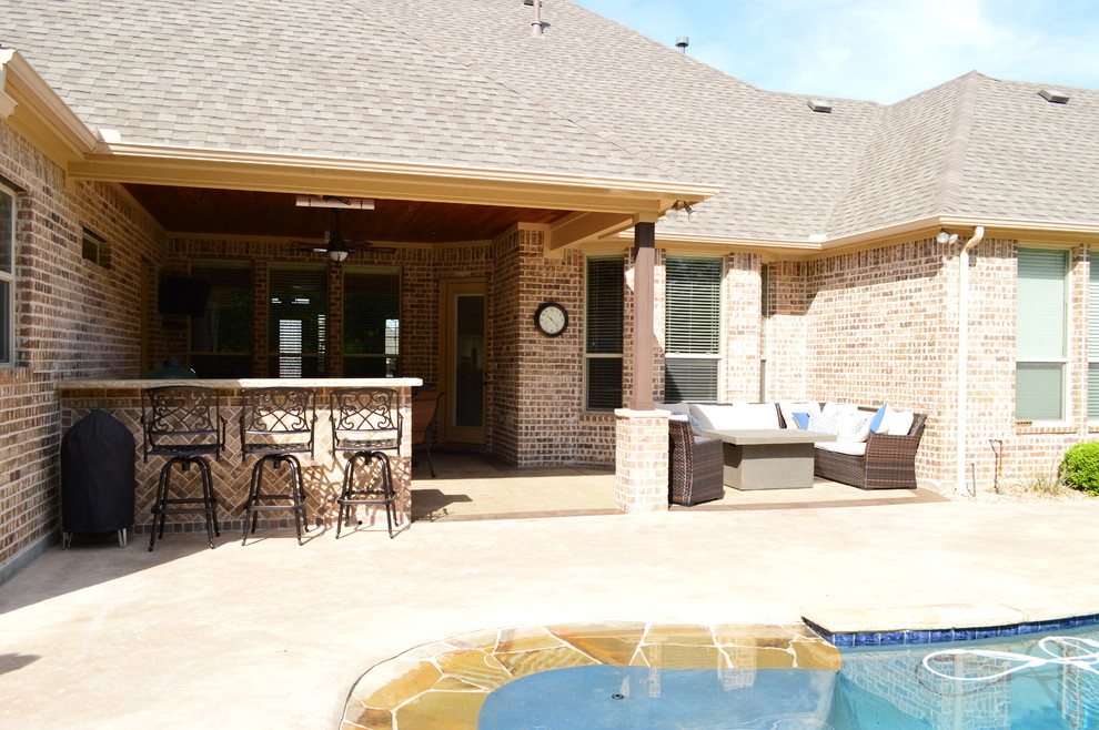 Inspiration for a medium sized rustic back patio in Dallas with an outdoor kitchen and stamped concrete.