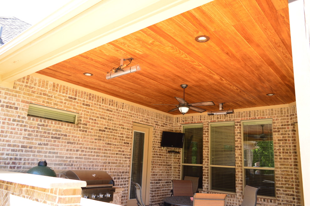 Inspiration for a medium sized rustic back patio in Dallas with an outdoor kitchen and stamped concrete.