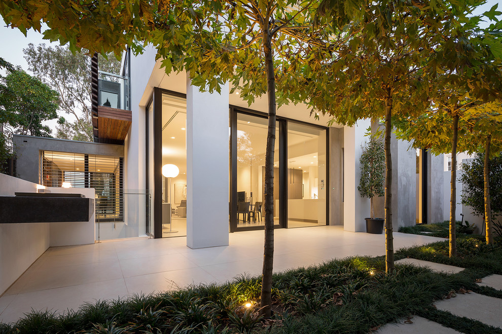 Contemporary patio in Melbourne with natural stone paving.