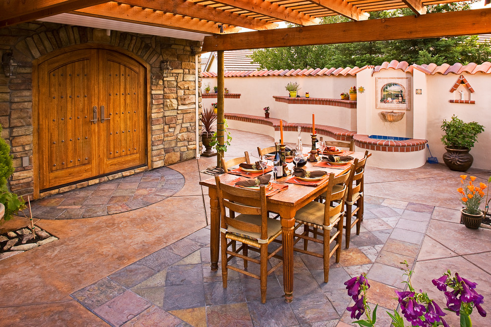 Mediterranean back patio in San Francisco with a pergola, a water feature and stamped concrete.
