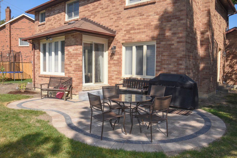 This is an example of a medium sized contemporary back patio in Other with concrete paving.