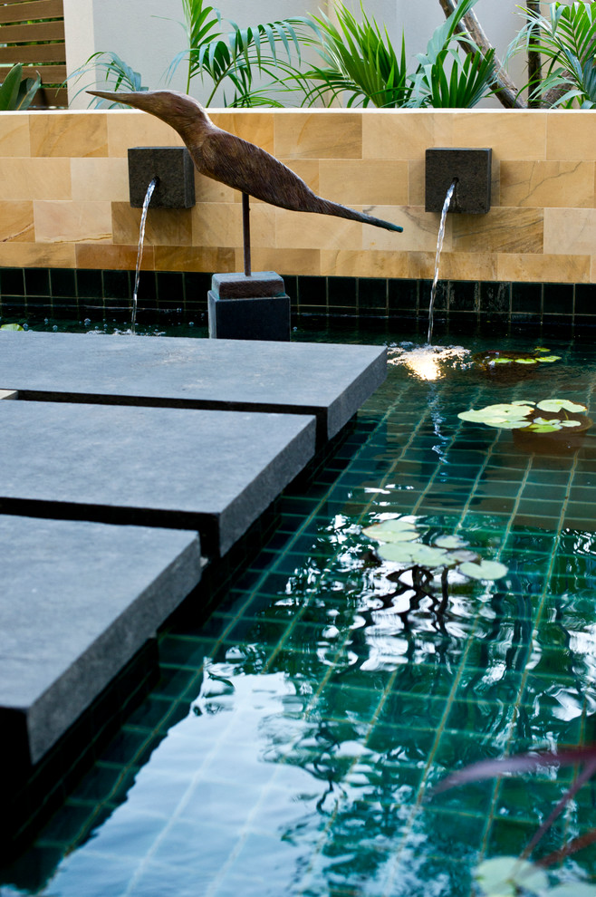 Inspiration for a small contemporary front yard stone patio fountain remodel in Perth