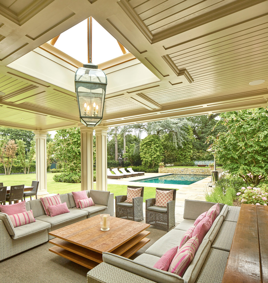 Photo of a traditional back patio in Surrey with a roof extension.