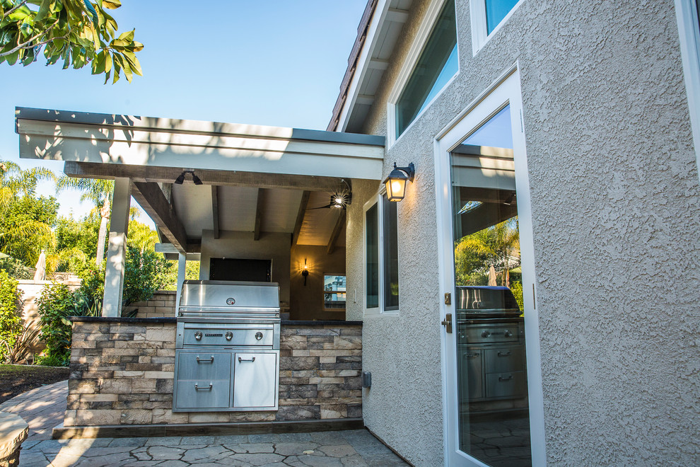 Inspiration for a mid-sized timeless backyard patio kitchen remodel in Los Angeles with decking and a roof extension