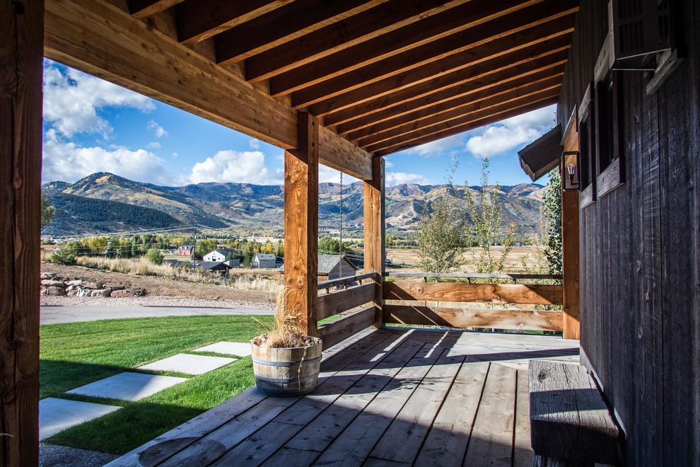 Photo of a large rustic back patio in Salt Lake City with a fire feature, gravel and no cover.