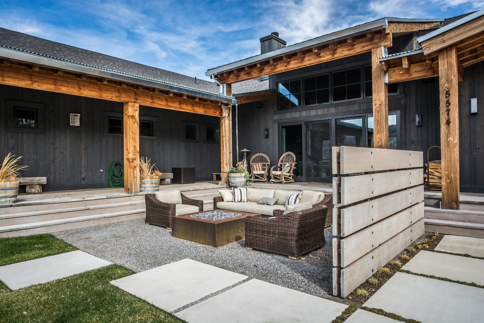 Inspiration for a large rustic front yard gravel patio remodel in Salt Lake City with a fire pit and no cover