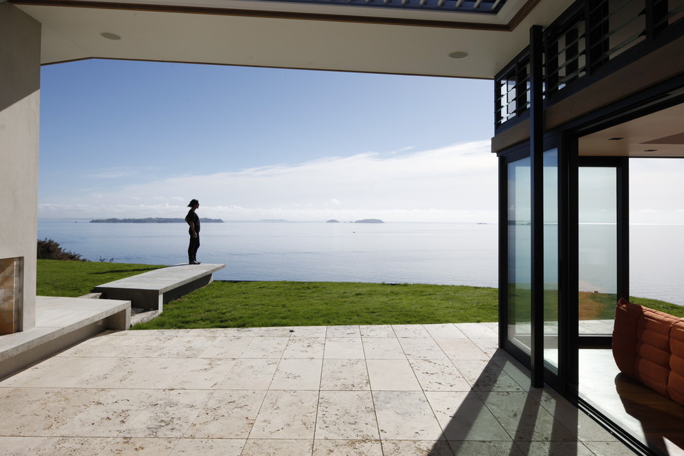 Patio - modern patio idea in Auckland with a fire pit