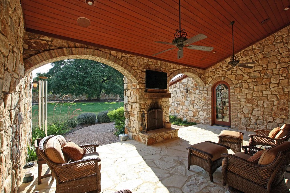 Inspiration for a mediterranean back patio in Austin with fencing.
