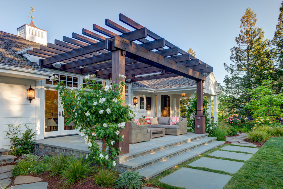 This is an example of a country back patio in San Francisco with a pergola.