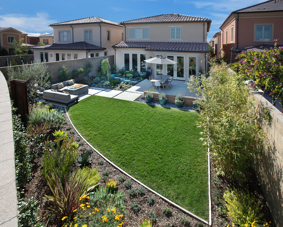 Inspiration for a mid-sized contemporary backyard concrete paver patio remodel in Orange County with no cover