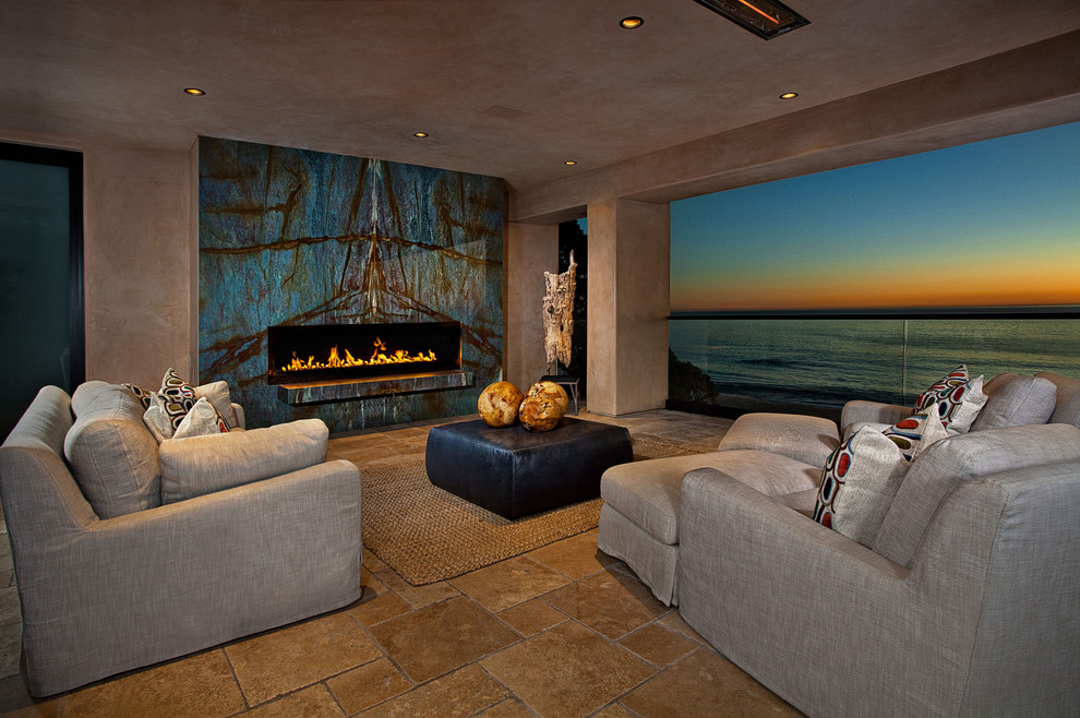 Inspiration for a contemporary patio in Orange County with a fire feature and a roof extension.