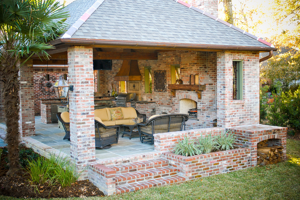 Photo of a large mediterranean back patio in New Orleans with an outdoor kitchen, brick paving and a gazebo.