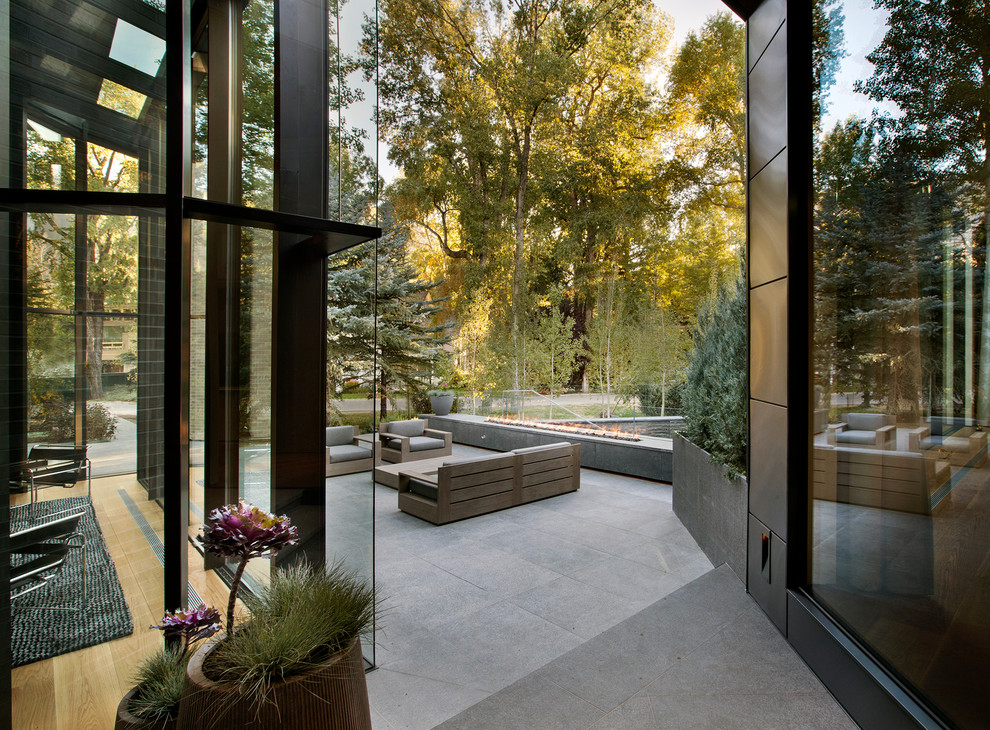 Photo of a contemporary back patio in Denver with a fire feature and no cover.