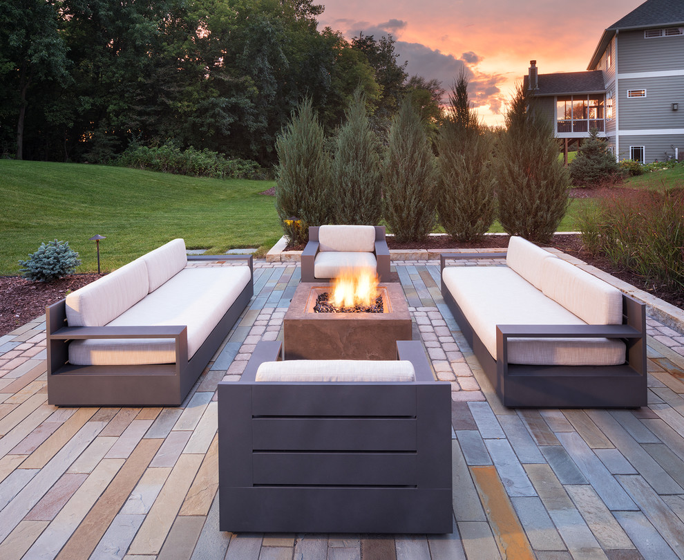 Example of a mid-sized trendy backyard concrete paver patio design in Minneapolis with a fire pit and no cover
