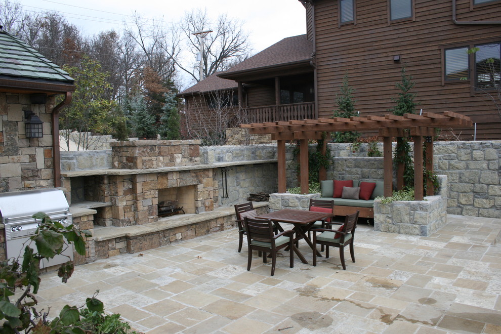Mountain style backyard tile patio photo in Kansas City with a fire pit and a pergola