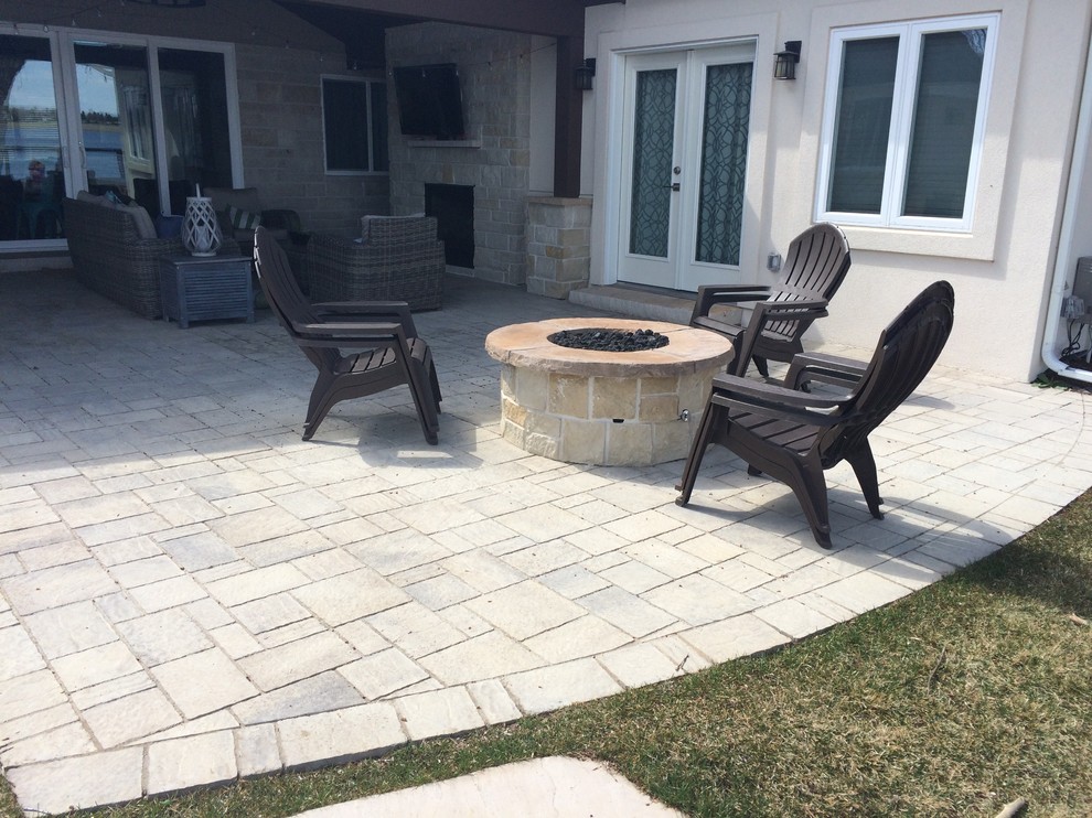 Design ideas for a classic back patio in Denver with a fire feature and concrete paving.