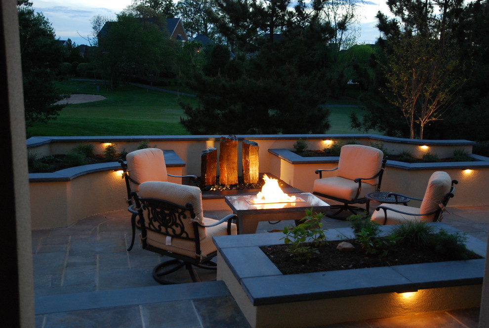 Inspiration for a small modern back patio in DC Metro with a fire feature and natural stone paving.