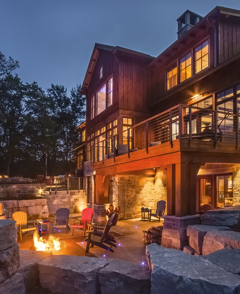 Inspiration for a rustic patio remodel in Milwaukee with a fire pit